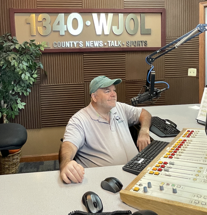 Brian at the 1340 WJOL station sitting behind the microphone and controls